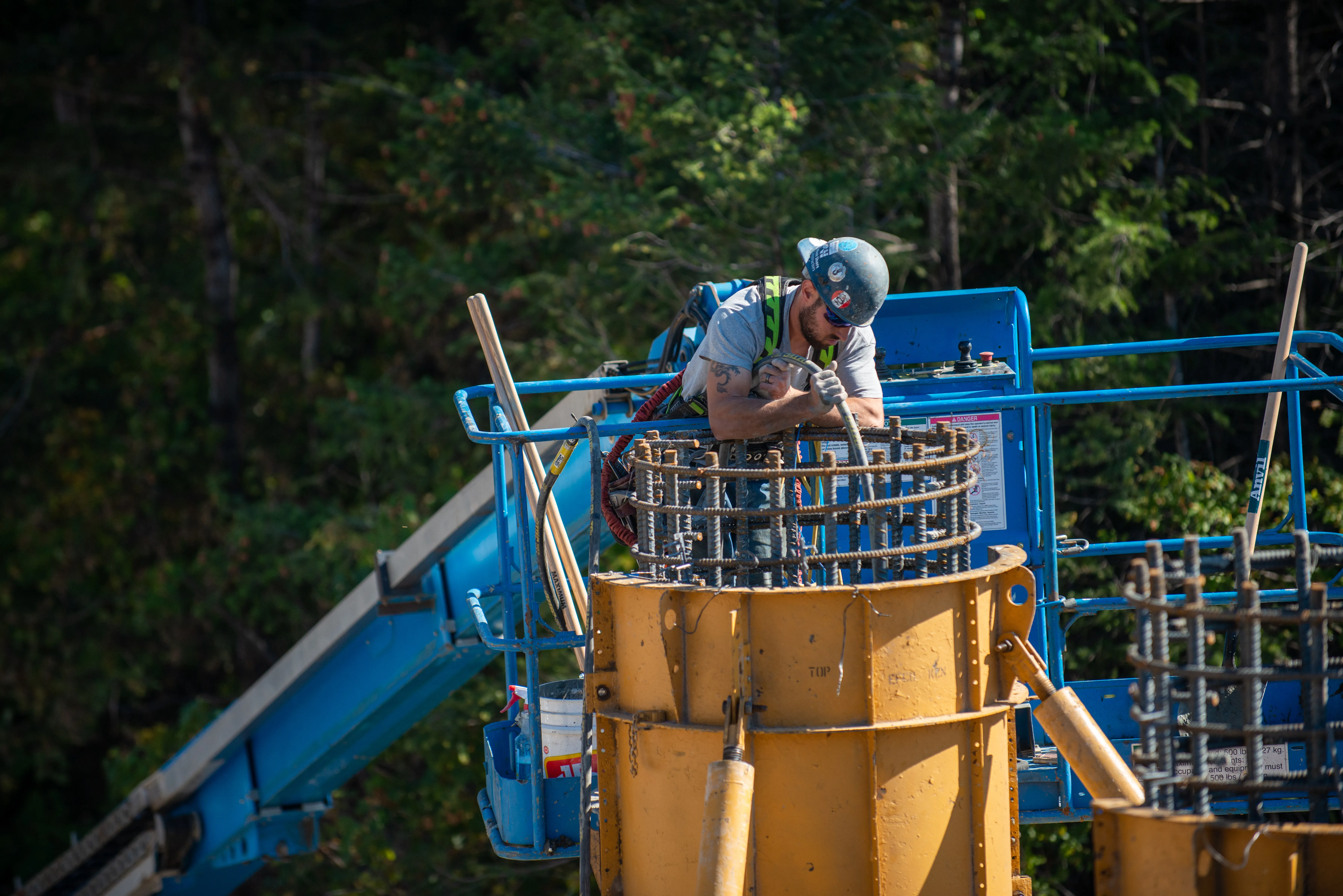 Mackay crew member tying a rebar pier cage from a man-lift
