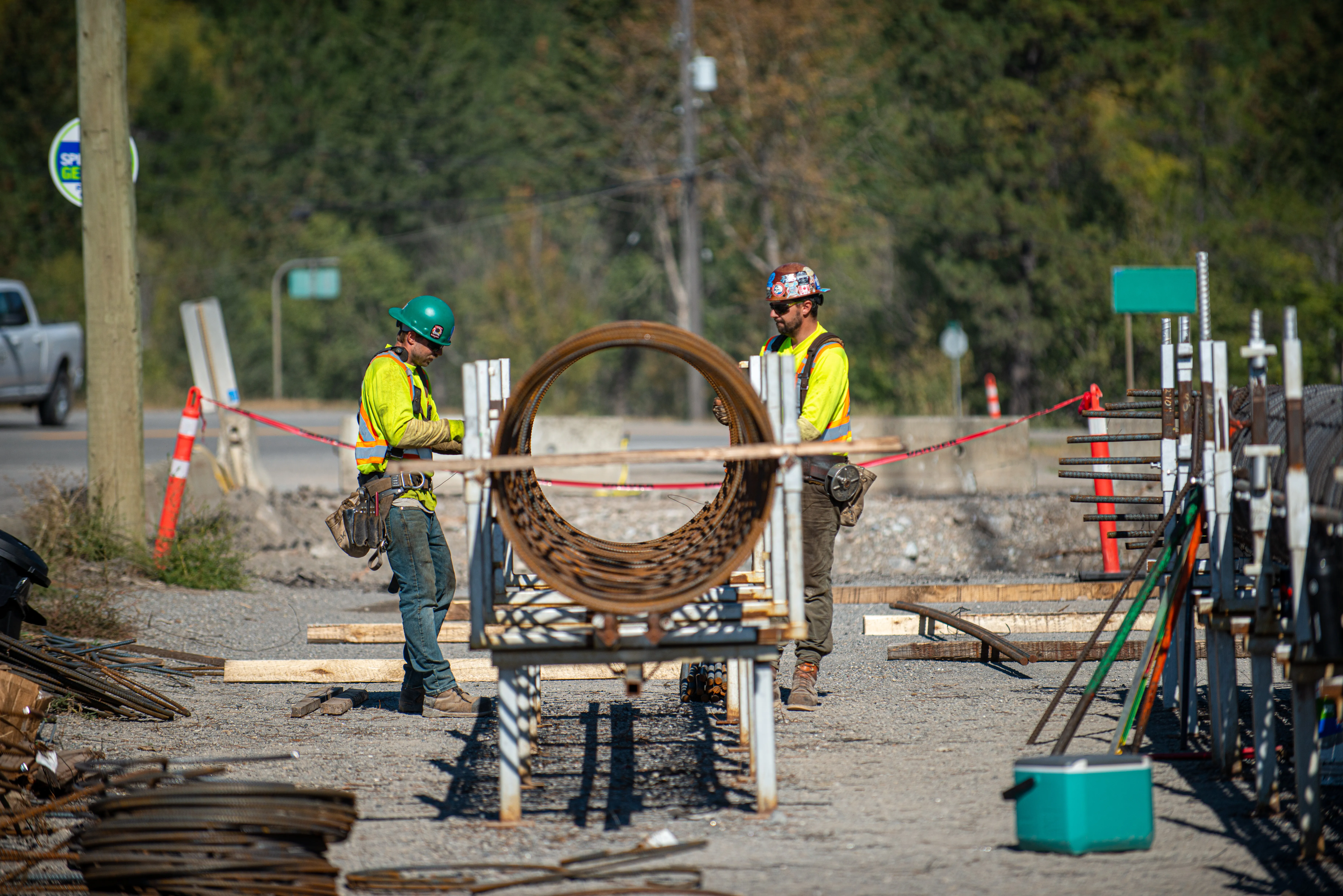 Crew members tying rebar reinforcing cages on a bridge project