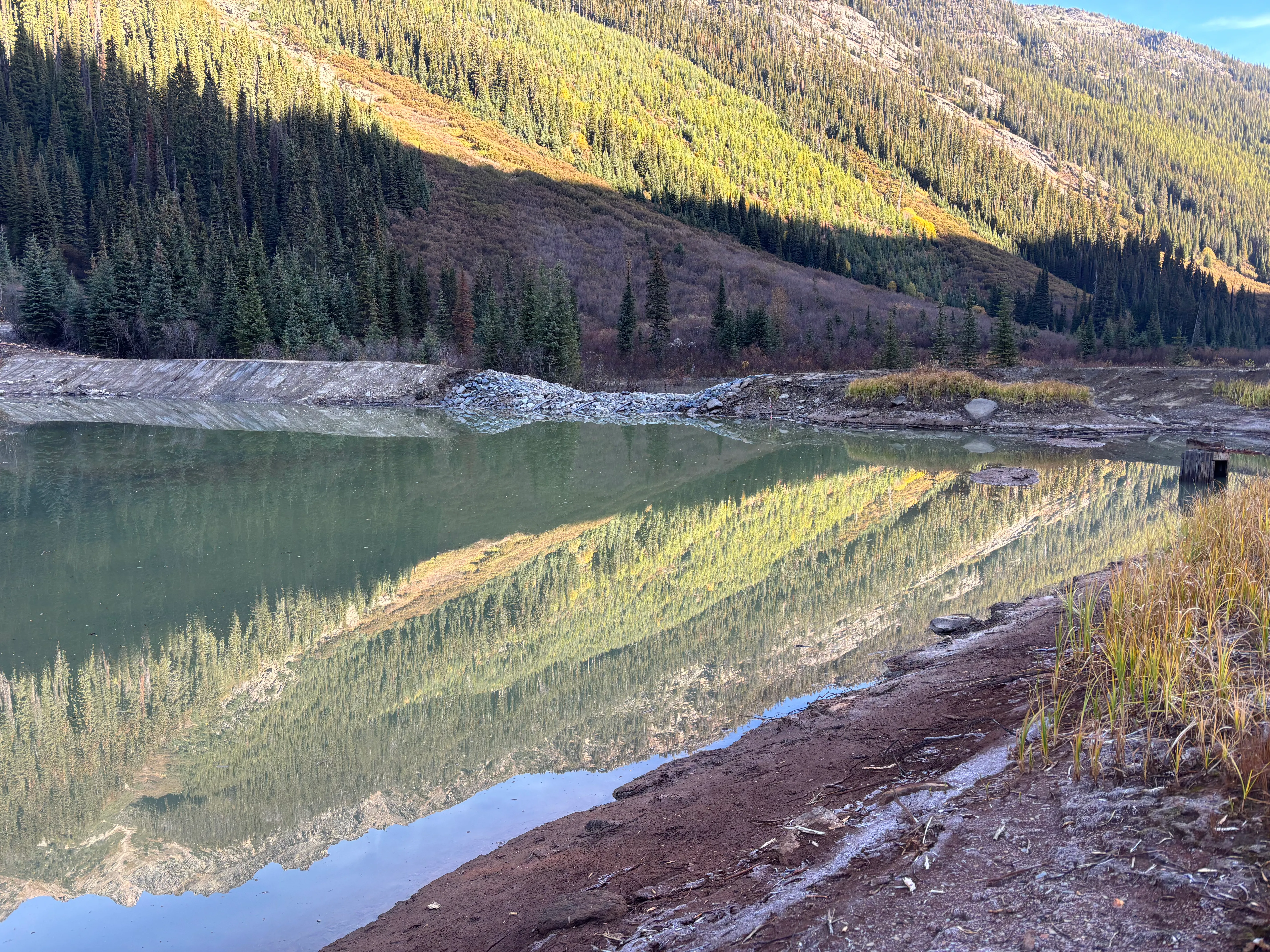 Restored tailings pond reflecting the mountainside at the Ruth Vermont site